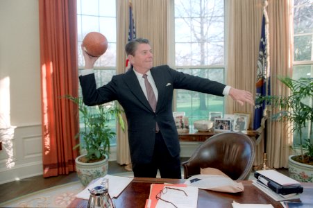 President Ronald Reagan throwing a football in the Oval Office photo