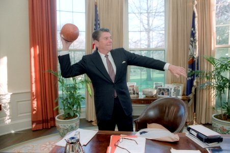 President Ronald Reagan throwing a football in the Oval Office