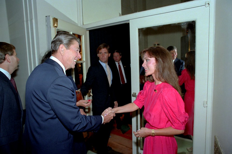 President Ronald Reagan shaking hands with skater Peggy Fleming