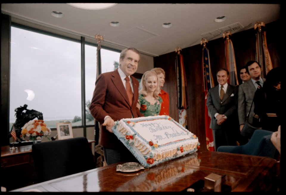 President Richard Nixon Admires His 61st Birthday Cake while Celebrating with Family and Staff Members at the Western White House (02)