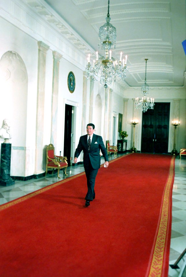 President Ronald Reagan walking in the Cross Hall