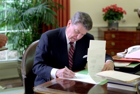 President Ronald Reagan signing veto of the Cranston resolution disapproving the Saudi Arabian arms in the Oval Office