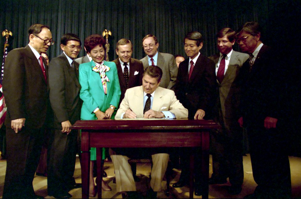 President Ronald Reagan signs the Reparations Bill for Japanese-Americans