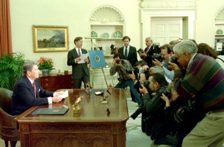 President Ronald Reagan sitting at his desk during his farewell address to the nation from the Oval Office