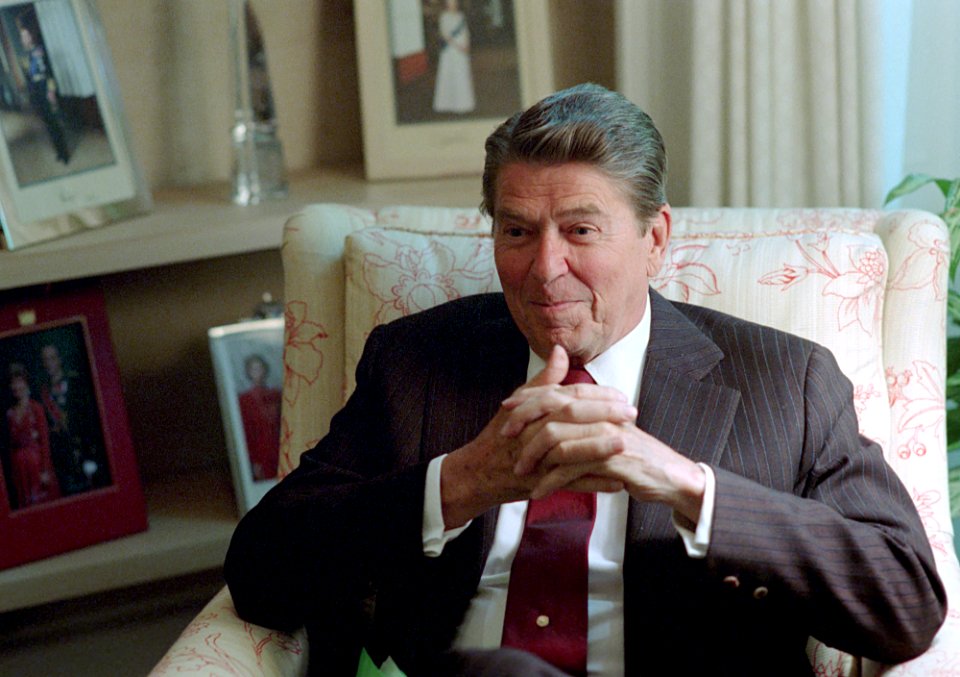 President Ronald Reagan sitting in the Oval Office Study
