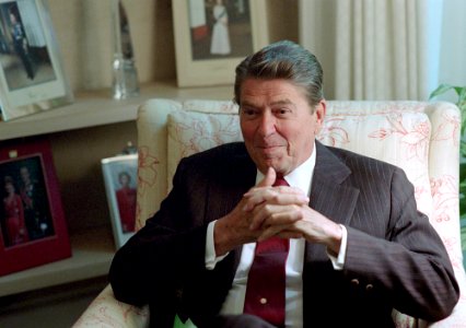 President Ronald Reagan sitting in the Oval Office Study photo