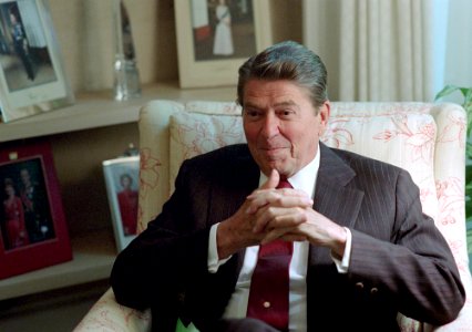 President Ronald Reagan sitting in the Oval Office Study
