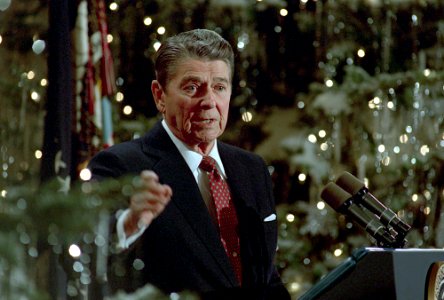 President Ronald Reagan speaking at a podium during his final press conference in the East Room photo