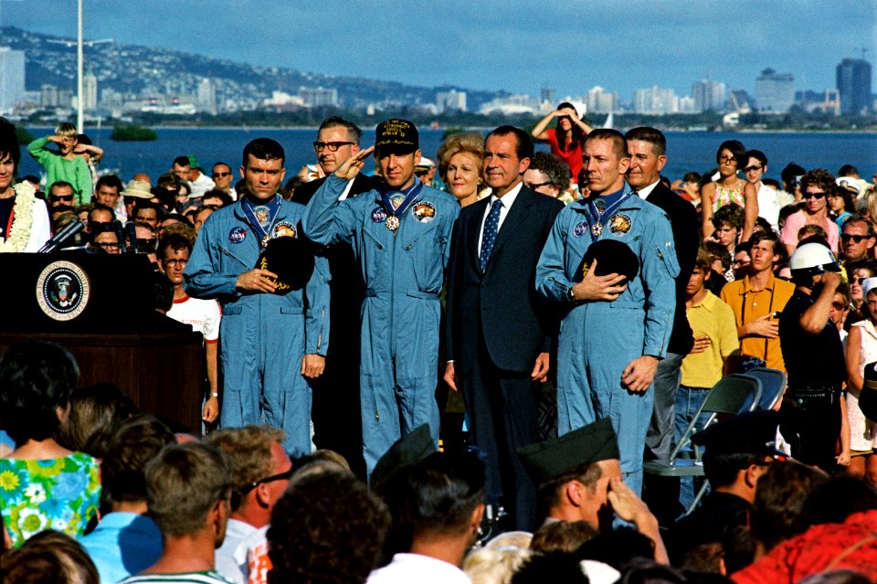 President Richard Nixon and the Apollo 13 astronauts stand at attention for the National Anthem at a ceremony