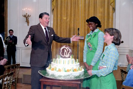 President Ronald Reagan viewing a birthday cake during a Luncheon in honor of the 72nd Anniversary of the Girl Scouts of America in the East Room