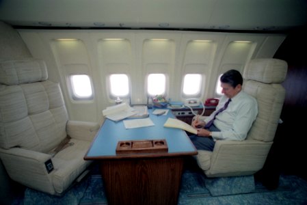 President Ronald Reagan working in his state room aboard Air Force One