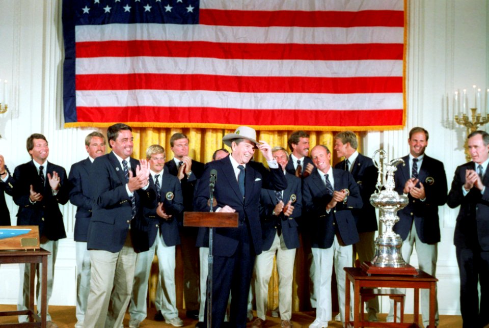 President Ronald Reagan wearing a hat during a Ceremony for the Stars and Stripes crew who won the America's Cup sailing race