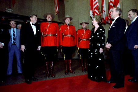 President Ronald Reagan, Nancy Reagan, and Prime Minister Pierre Trudeau meeting with Royal Canadian mounted police during a visit to National Arts Center in Ottawa, Canada
