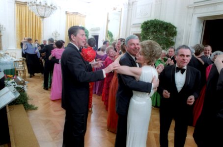 President Ronald Reagan cutting in on Nancy Reagan and Frank Sinatra dancing at the President's birthday party in the East Room photo