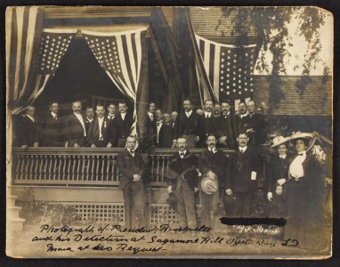 President Roosevelt and his detectives at Sagamore Hill, Oyster Bay, L.I., posed on porch with flags LCCN92520940 photo