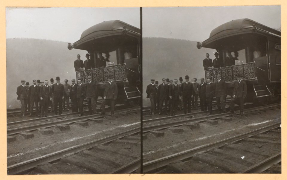 President Roosevelt, standing with twelve other men on railroad tracks, in front of locomotive LCCN91712439