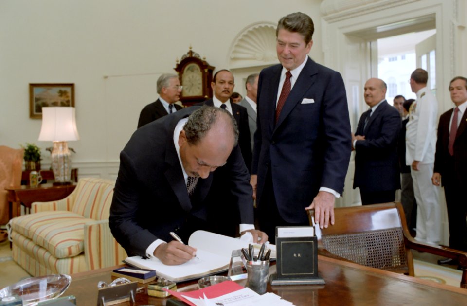 President Sadat of The Arab Republic of Egypt Signs Guest Book As President Ronald Reagan Looks on in The Oval Office