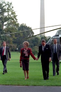 President Ronald Reagan and Nancy Reagan holding hands after arriving back to the White House