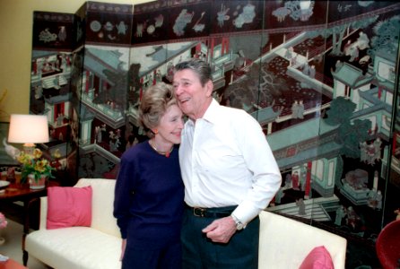 President Ronald Reagan and Nancy Reagan hugging during their 36th wedding anniversary in the White House residence