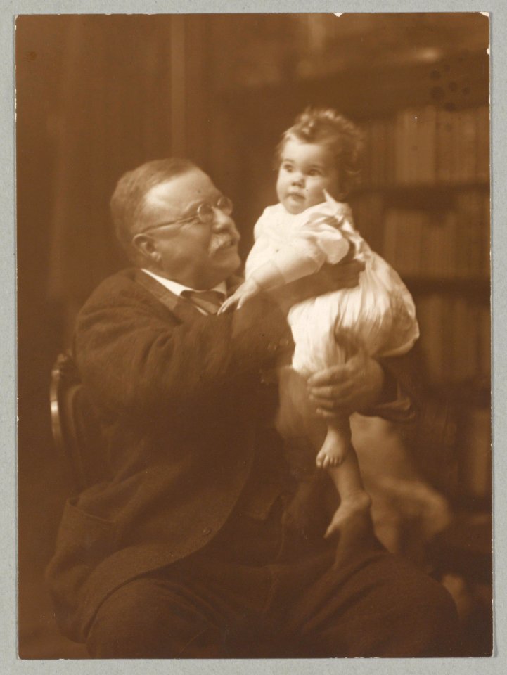 President Roosevelt, seated, holding an infant grandchild LCCN2009631453