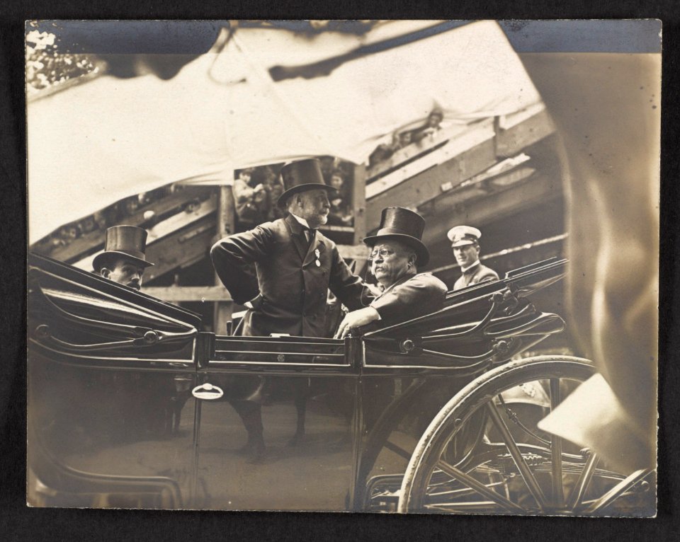 President Theodore Roosevelt sitting in an open carriage, accompanied by two other men LCCN2013651469
