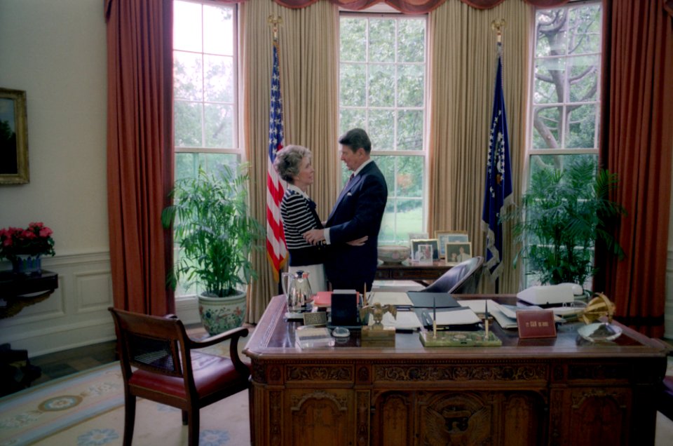 President Ronald Reagan and Nancy Reagan talking in the Oval Office