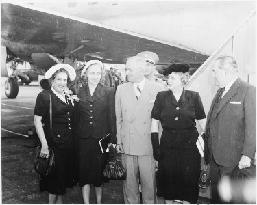 President Truman and his party prepare to board the presidential airplane to fly to Brazil. L to R, Mrs. Carlos... - NARA - 199690