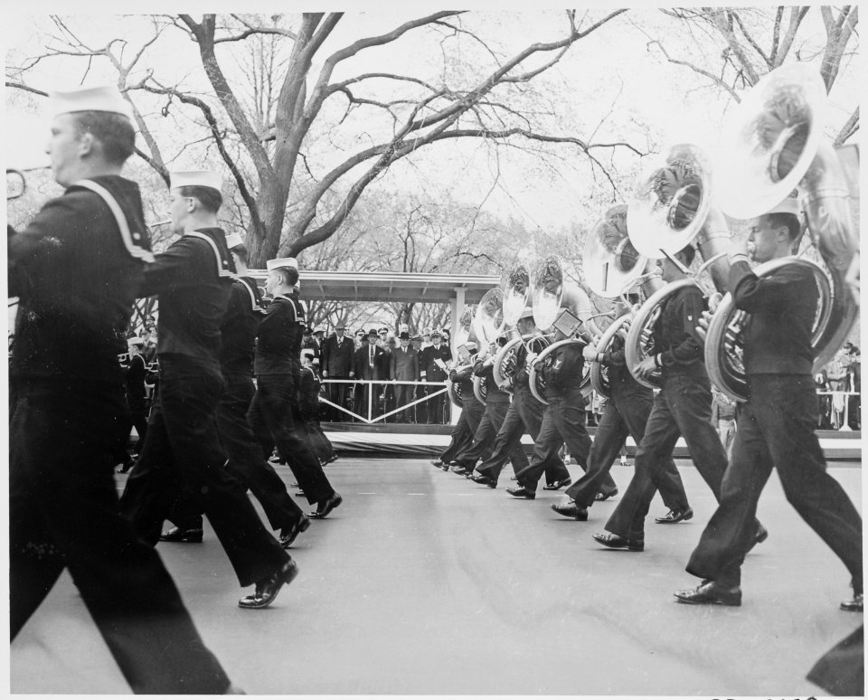 President Truman at the reviewing stand (in distance) as the Navy band marches by (foreground) during the Army Day... - NARA - 199767
