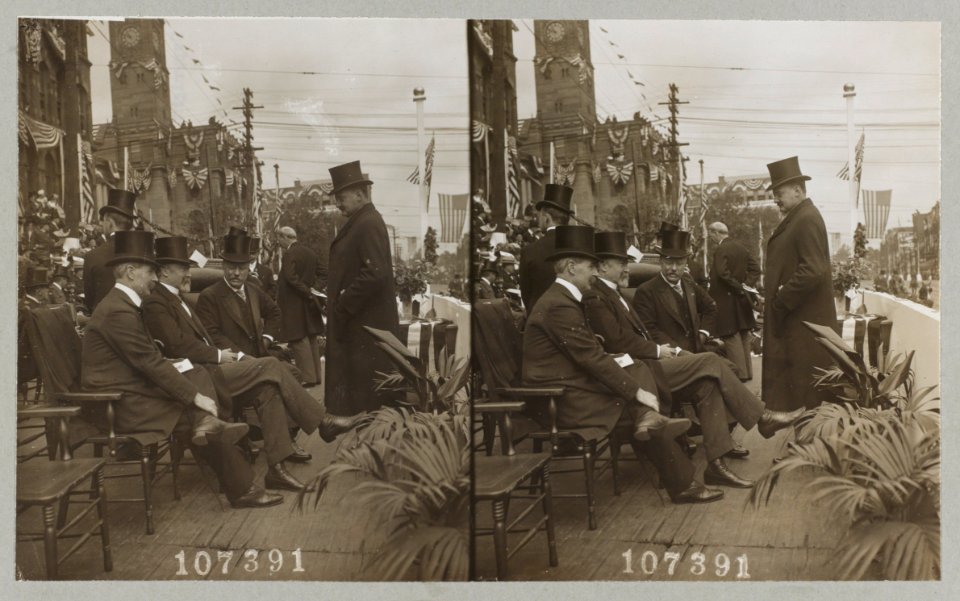 President Theodore Roosevelt seated talking with men at parade LCCN2013645461