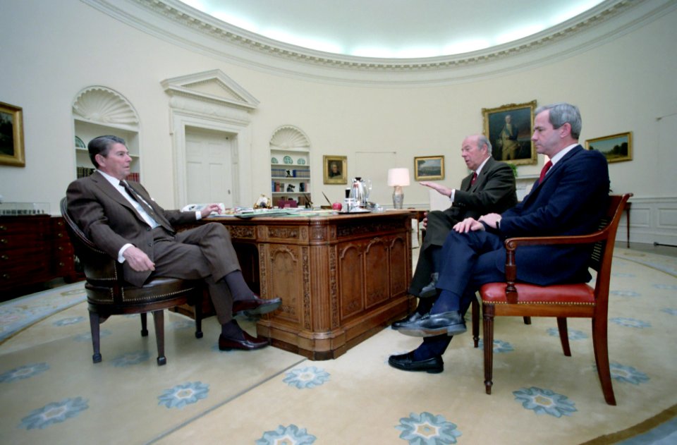 President Ronald Reagan meeting with George Shultz and Robert McFarlane in the Oval Office