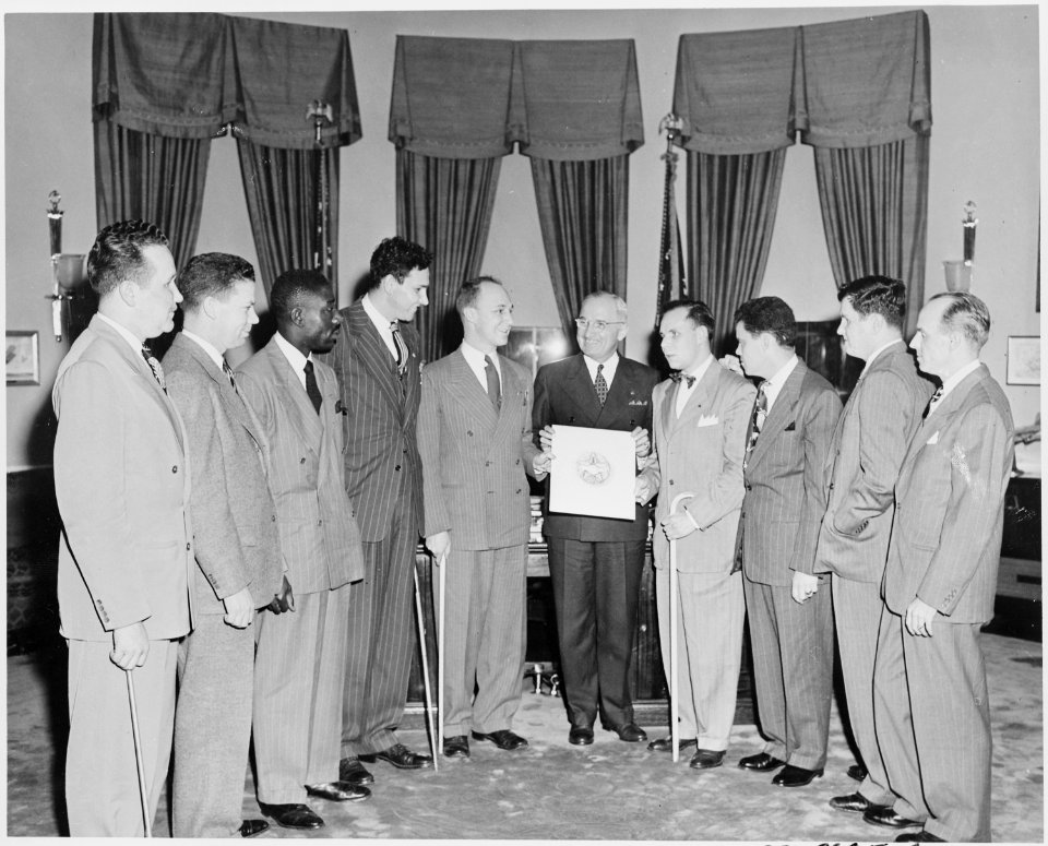 President Truman in the oval office receiving the official insignia of the Blinded Veterans Association. L to R... - NARA - 199762