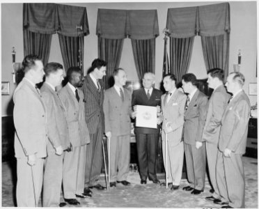 President Truman in the oval office receiving the official insignia of the Blinded Veterans Association. L to R... - NARA - 199762