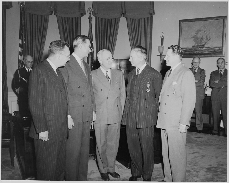 President Truman in the oval office with four men who received the Medal of Merit. L to R, W. John Kennedy... - NARA - 199639