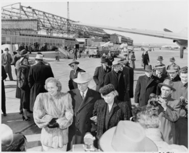 President Truman poses with his wife and daughter, Bess and Margaret Truman, at the airport upon his return to... - NARA - 199782