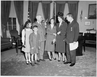 President Truman poses with Undersecretary of the Navy W. John Kennedy and his family in the oval office. Mr. Kennedy... - NARA - 199635 photo