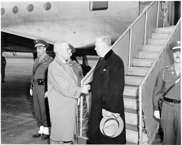 President Truman shakes hands with Secretary of State George Marshall as Secretary Marshall is about to leave on an... - NARA - 199676 photo