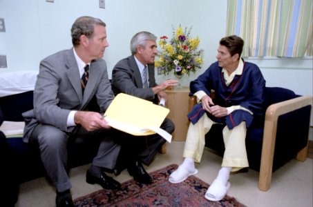 President Ronald Reagan meeting with Senator Paul Laxalt and James Baker at George Washington hospital