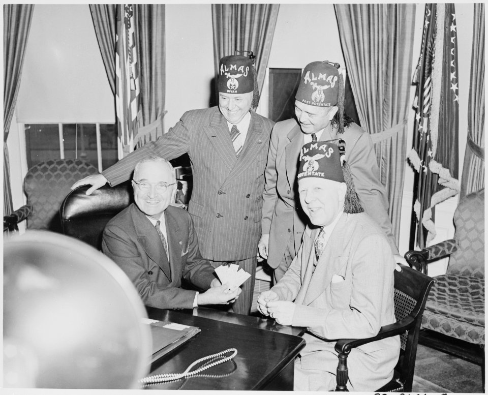 President Truman, in the oval office, receives a bid to open the first performance of the 8th annual Shrine circus on... - NARA - 199764