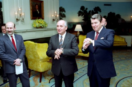 President Ronald Reagan and Soviet General Secretary Mikhail Gorbachev checking their watches while waiting for their wives in the White House Diplomatic Reception room
