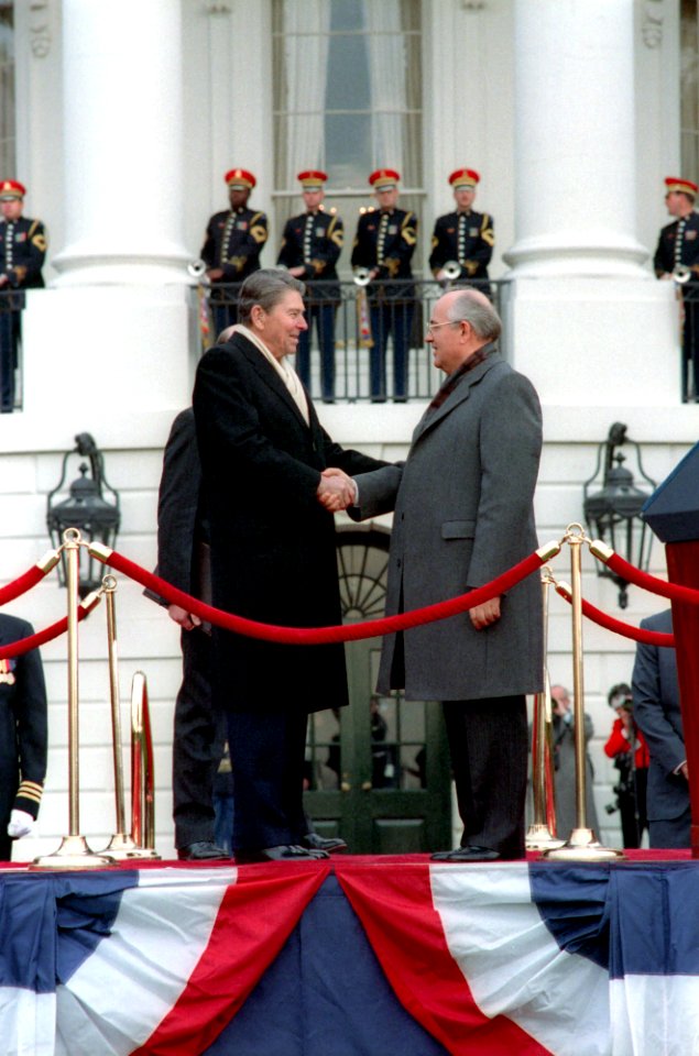 President Ronald Reagan and Soviet General Secretary Mikhail Gorbachev shaking hands at the arrival ceremony on the White House south lawn