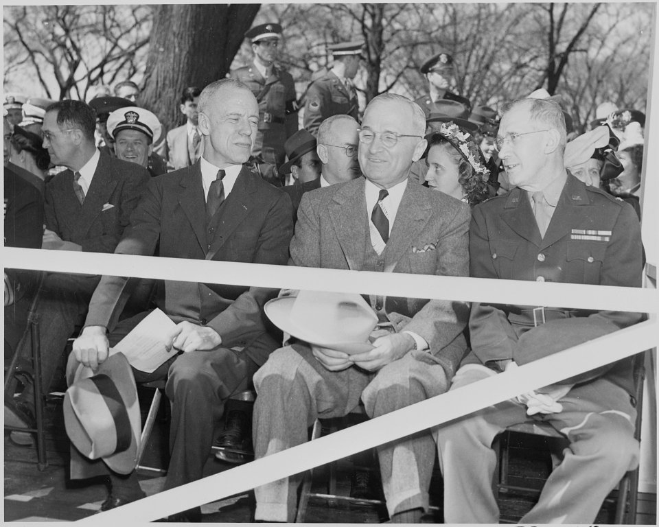 President Truman attends an Army Day parade in Washington, D. C. He is seated on the reviewing stand between two... - NARA - 199604