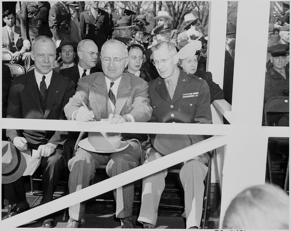 President Truman attends the Army Day parade in Washington, D. C. He is seated between two unidentified men.... - NARA - 199615