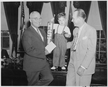 President Truman greets little Michael Gene Condatore of Washington and E. F. Harloff in the oval office. Little... - NARA - 199722