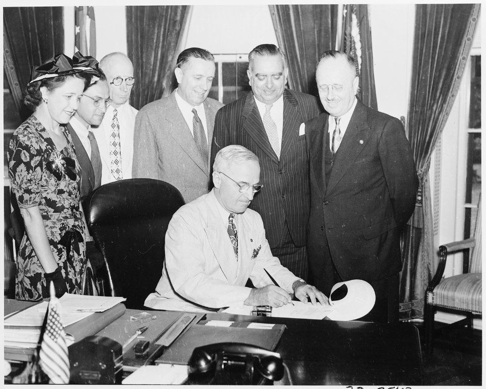 President Truman in the oval office signing a bill to make the governship of Puerto Rico an elected office. L to R... - NARA - 199701