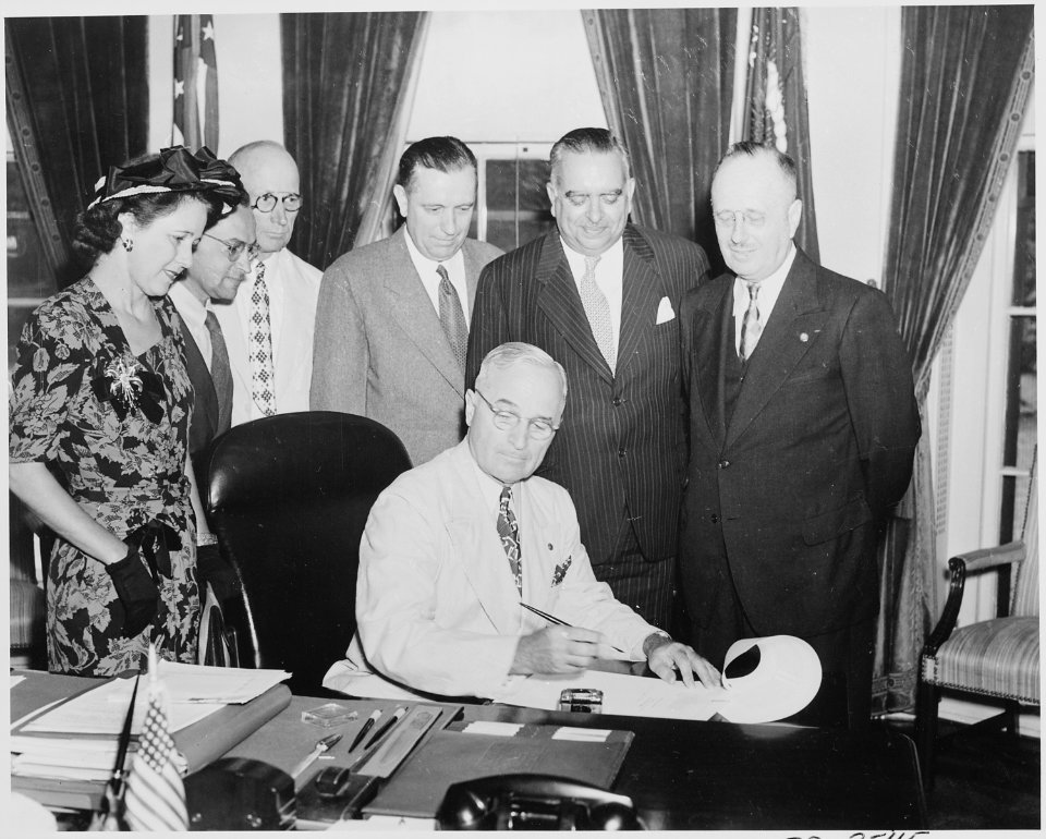 President Truman signing a bill in the oval office making the governorship of Puerto Rico an elected office. L to R... - NARA - 199699