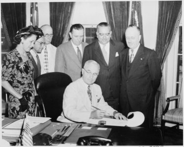 President Truman signing a bill in the oval office making the governorship of Puerto Rico an elected office. L to R... - NARA - 199699
