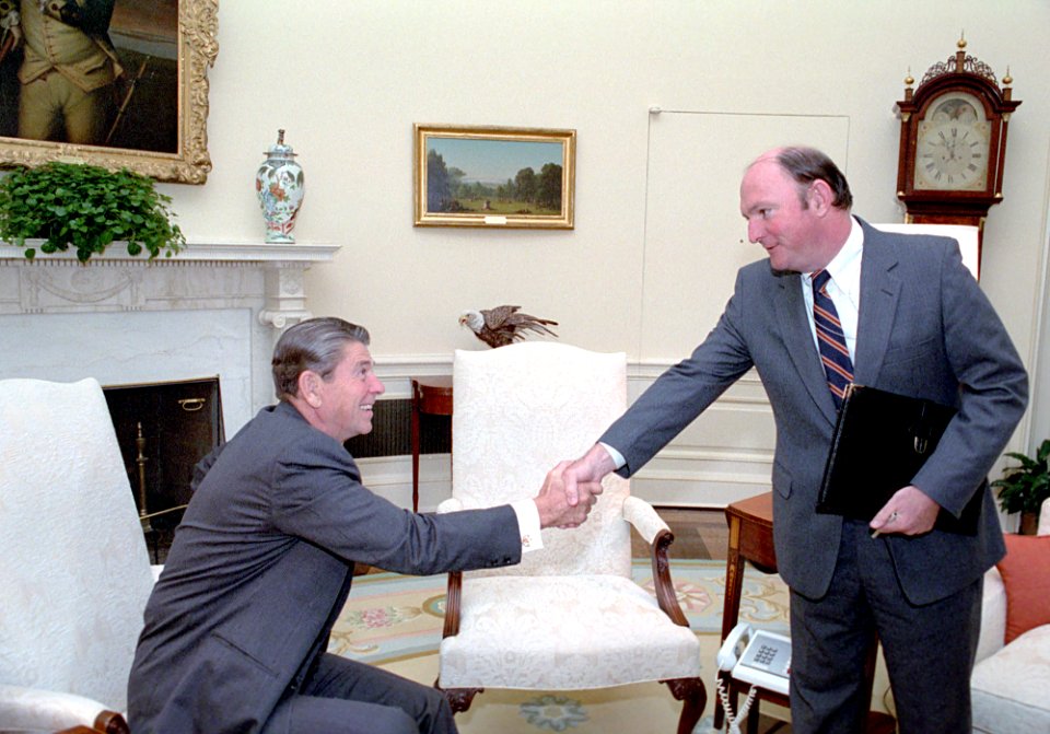 President Ronald Reagan shaking hands with Marlin Fitzwater in the Oval Office