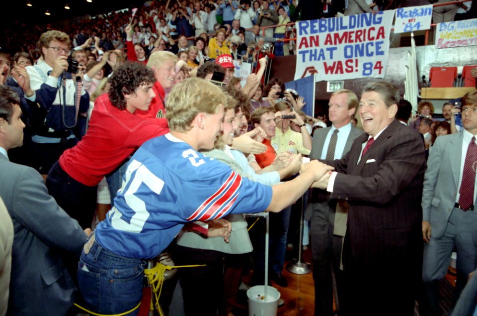 President Ronald Reagan shaking hands with unidentified members of the crowd while at Bowling Green University in Ohio