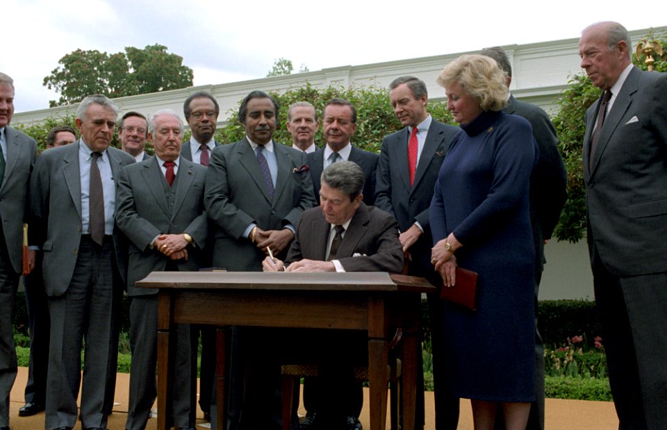 President Ronald Reagan signs Executive Order 12595