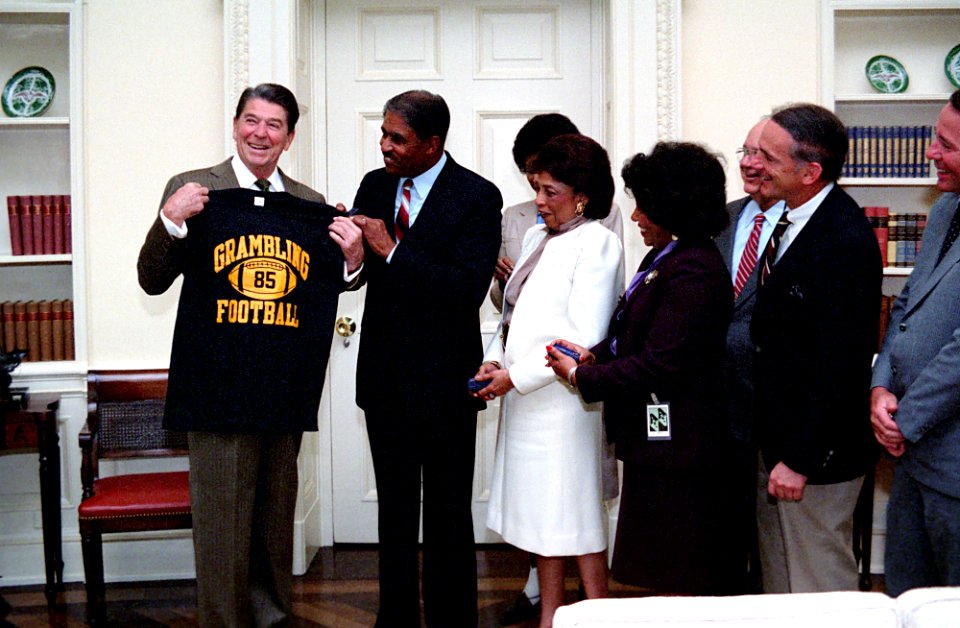 President Ronald Reagan during a photo op. with Coach of Grambling State university football team Eddie Robinson in the Oval Office